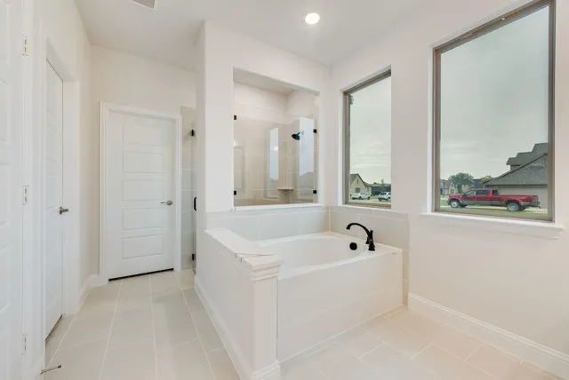 a bathroom with a bathtub and a window