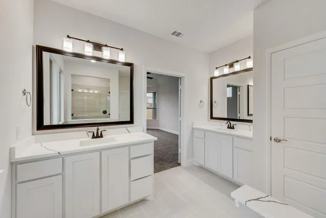 a bathroom with 2 sink and a mirror