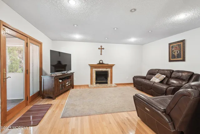 a living room with furniture a flat screen tv and a fireplace