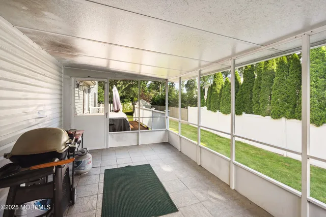 a view of a porch with furniture and a gate