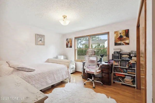 a bedroom with a bed and a bookshelf