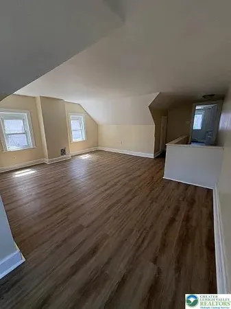 a view of an empty room and wooden floor