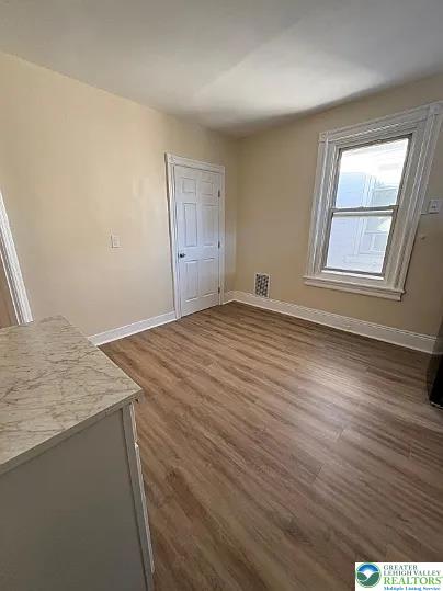 520 Fiot Avenue, Unit 2 Bethlehem, PA 18015 - Photo 9 of 23 an empty room with wooden floor and windows