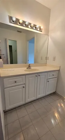 a bathroom with a sink vanity and mirror