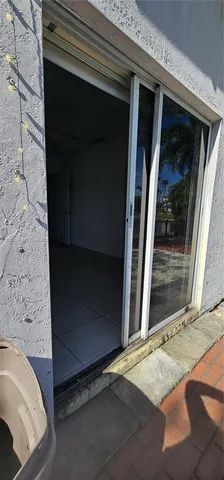 a view of a lake with a floor to ceiling yard next to a large tree