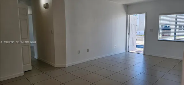 an empty room with windows and closet