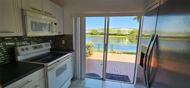 a kitchen that has a sink and a stove