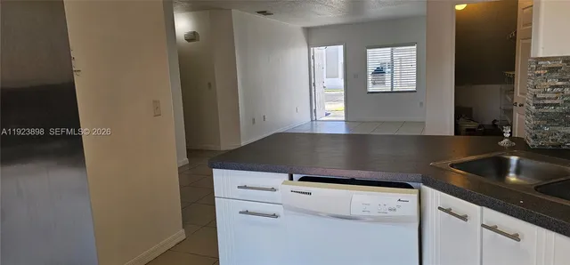 a kitchen with a sink cabinets and a window