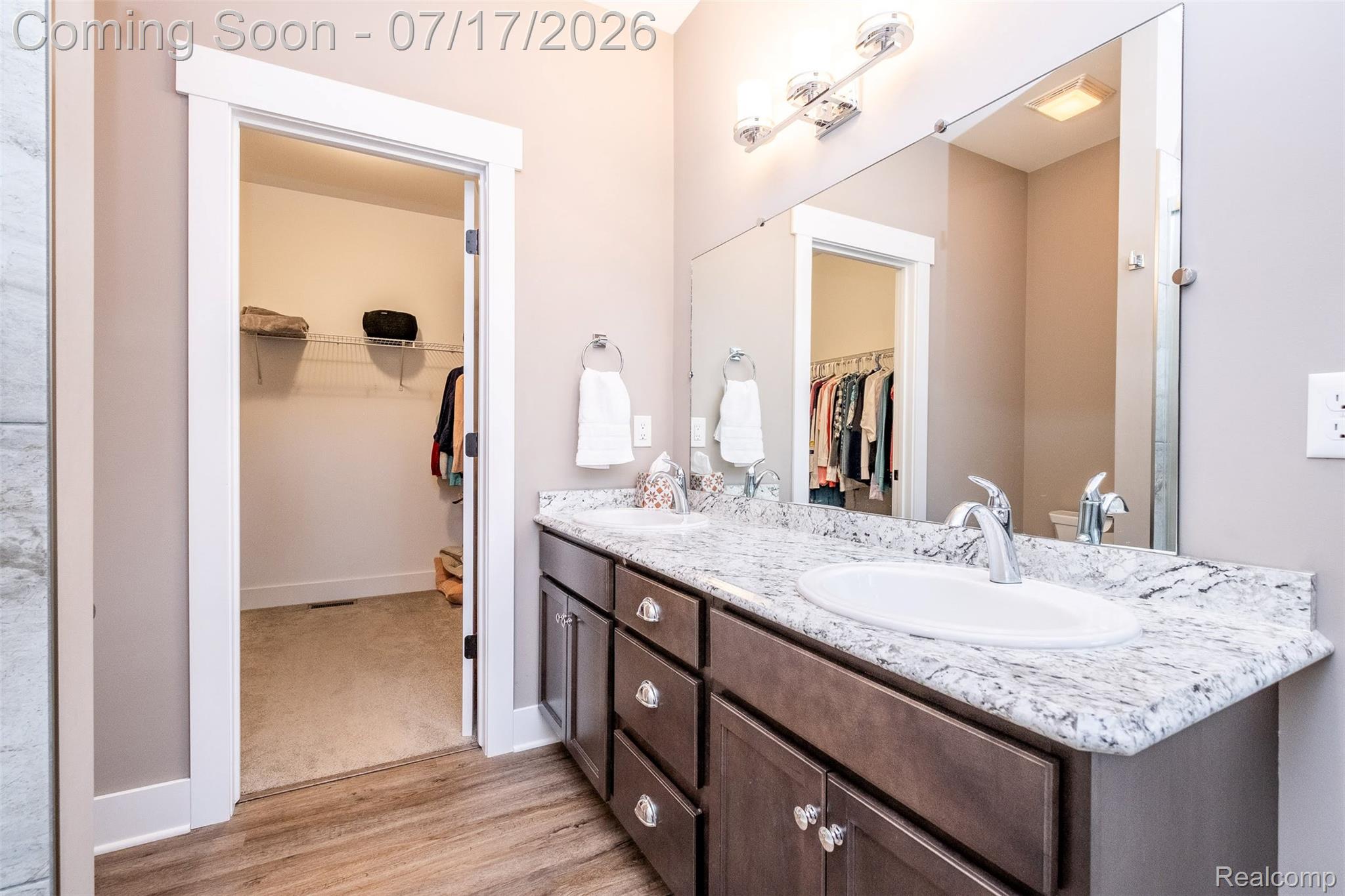 12349 Sugar Maple Drive Fenton, MI 48430 - Photo 29 of 67 Bathroom vanity featuring a dual sink design, stone countertop, and wood-finish cabinetry