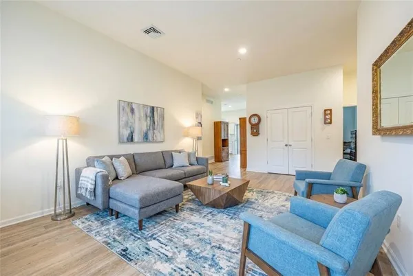 a living room with furniture and a lamp
