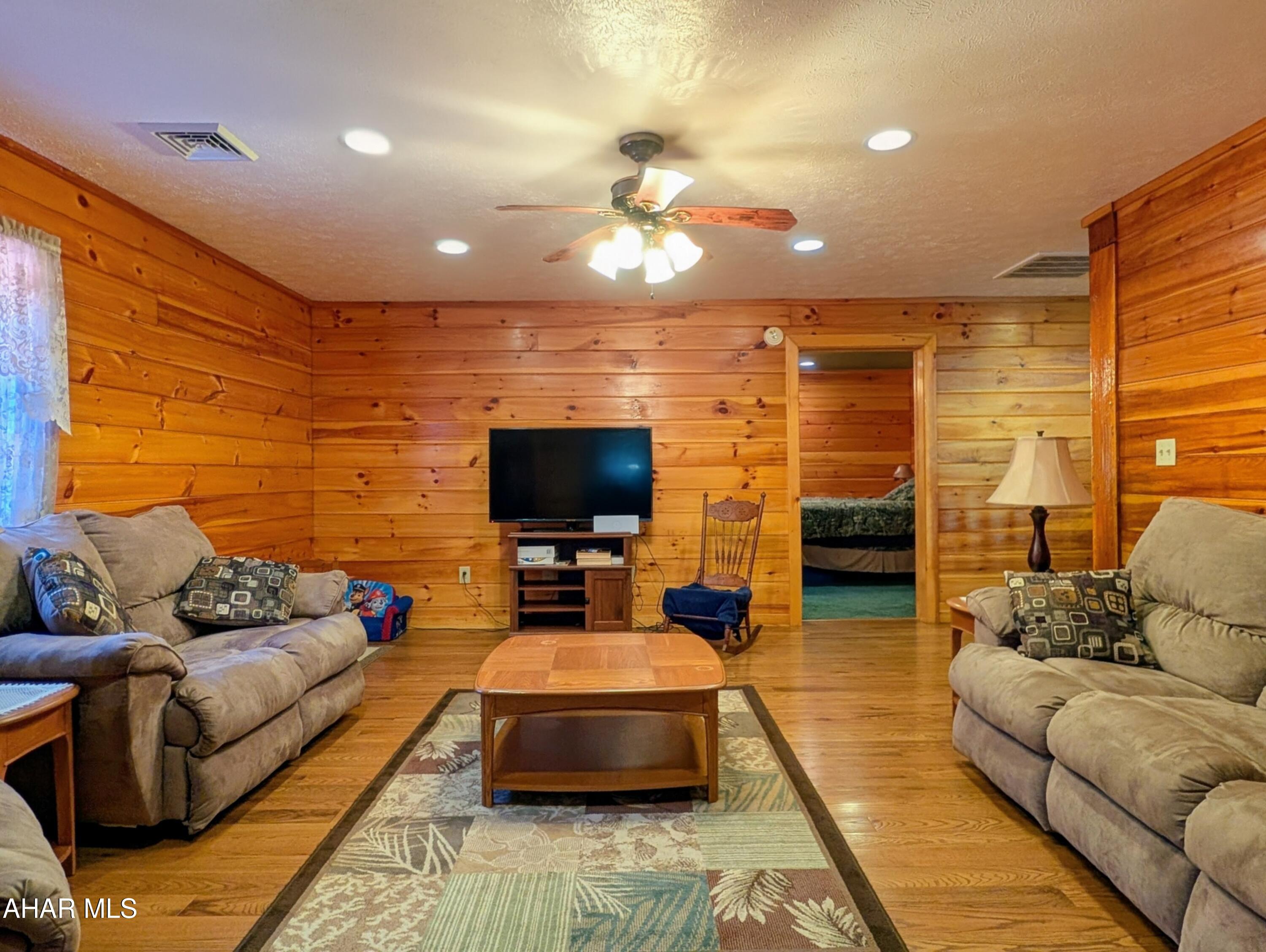 213 Sherman Valley Road Hopewell, PA 16650 - Photo 59 of 104 a living room with furniture and a flat screen tv