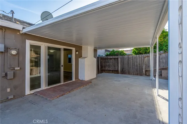 a view of a house with backyard and floor to ceiling window