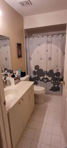 a bathroom with a sink mirror and tub