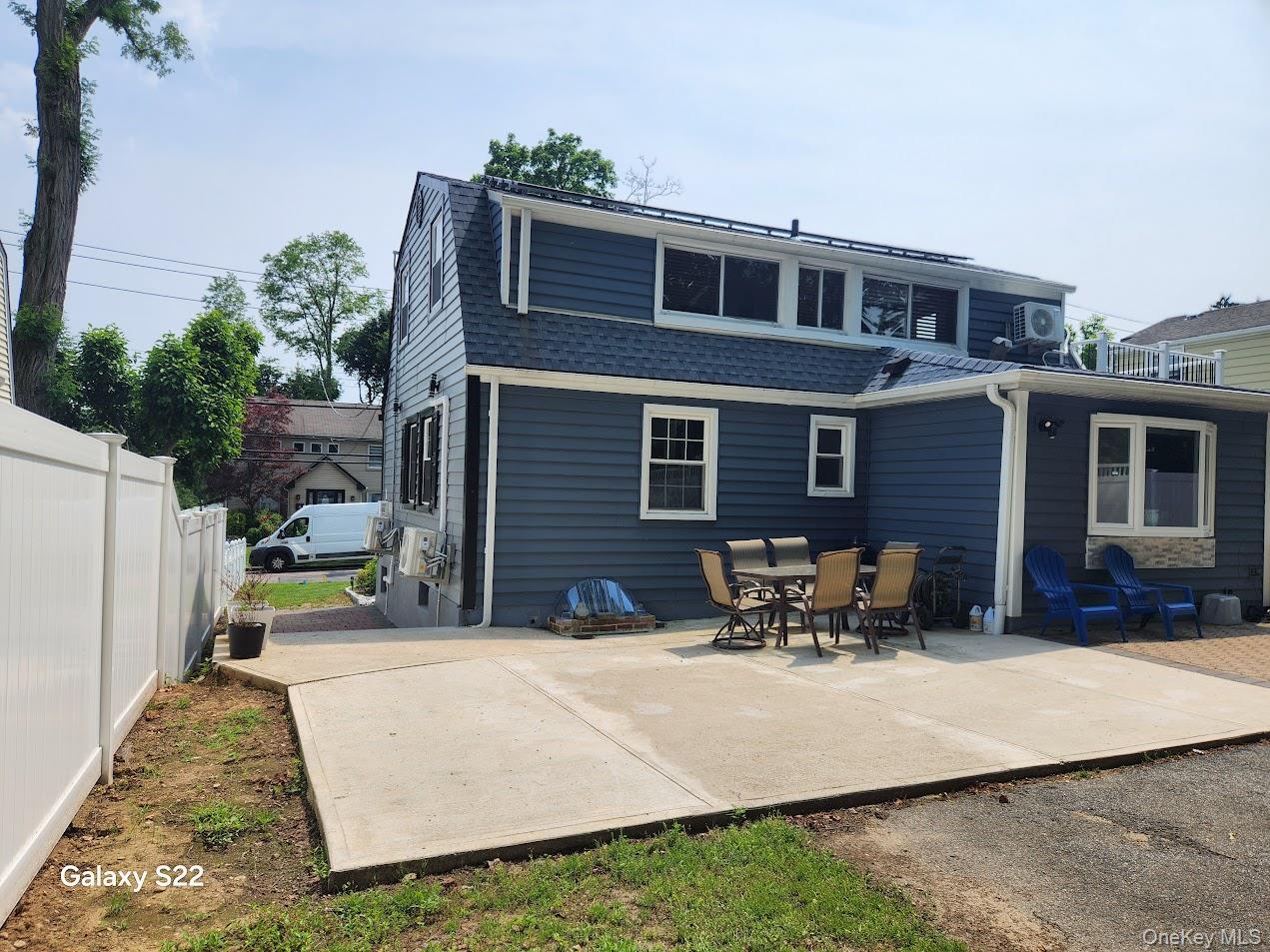 46 Randolph Road White Plains, NY 10607 - Photo 3 of 18 Rear view of property featuring a shingled roof and a patio area