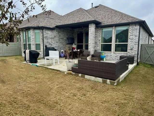 a view of a patio with table and chairs and potted plants