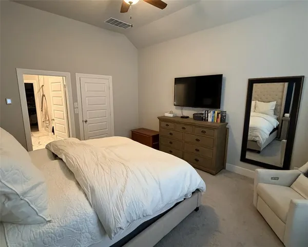 a bedroom with a bed and a flat screen tv