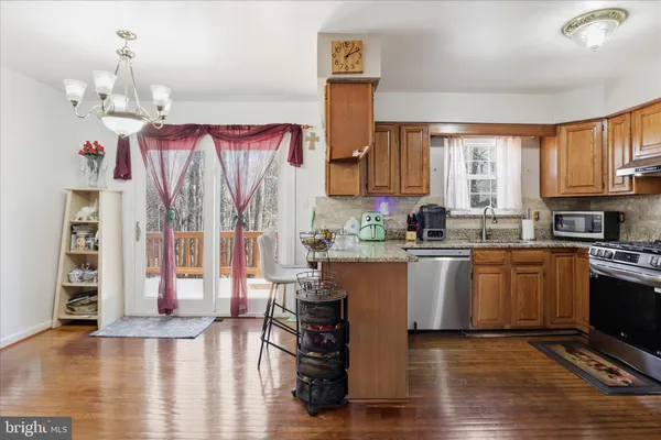 a kitchen with a refrigerator cabinets and wooden floor