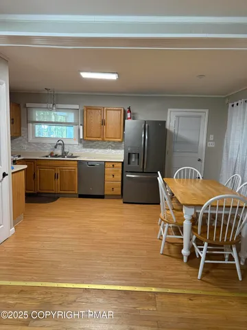 a kitchen with granite countertop a sink stainless steel appliances and cabinets
