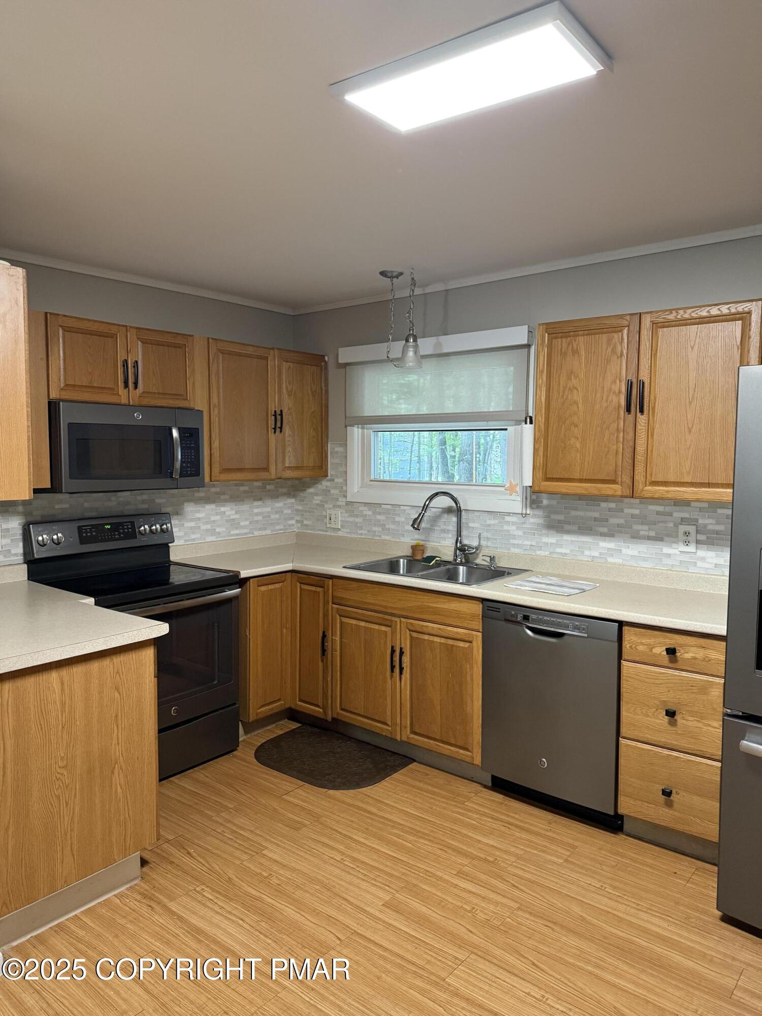 1146 Colt Lane Pocono Summit, PA 18346 - Photo 12 of 18 a kitchen with granite countertop a sink stainless steel appliances and cabinets