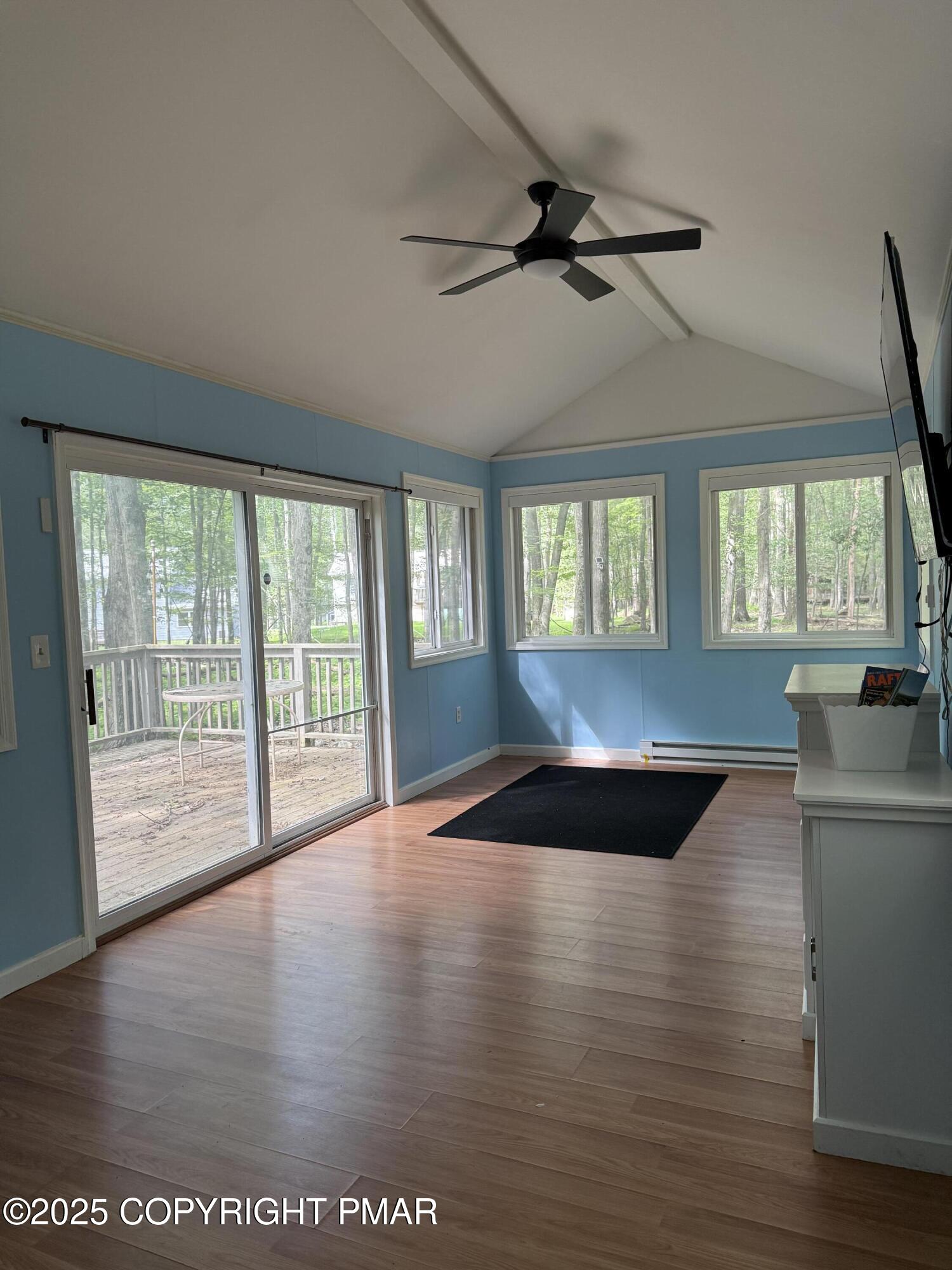 1146 Colt Lane Pocono Summit, PA 18346 - Photo 14 of 18 a living room with a large window wooden floor and a rug