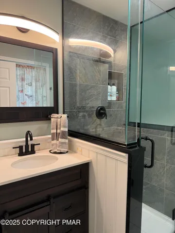 a bathroom with a shower and a sink