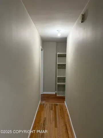 a room with a wooden floor and chandelier