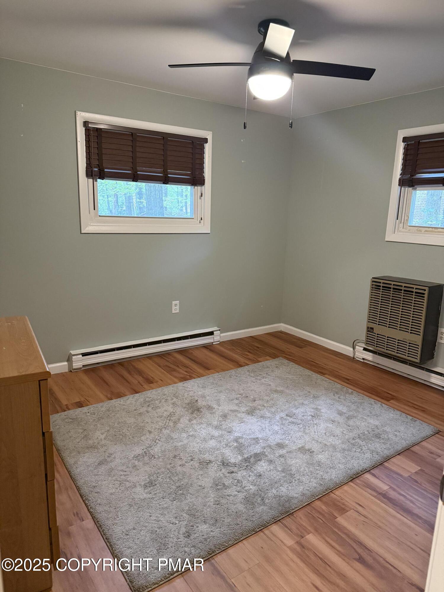 1146 Colt Lane Pocono Summit, PA 18346 - Photo 7 of 18 a room with a wooden floor and chandelier