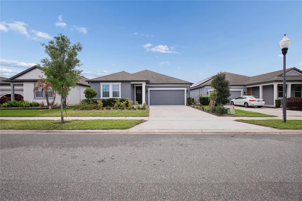 5732 Iron Brand Road St. Cloud, FL 34771 - Photo 2 of 25 a view of a house with a big yard and large trees