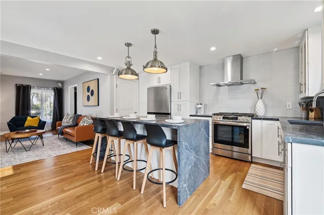 a bedroom with a bed and a large mirror next to a window