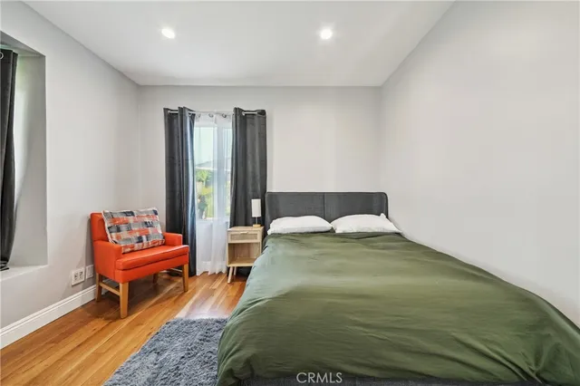 a spacious bedroom with a bed and a couch