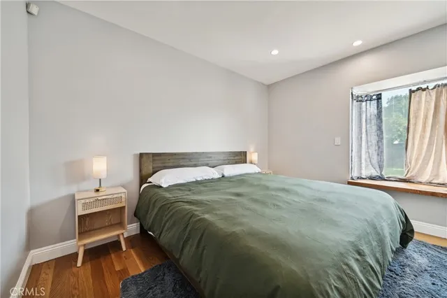 a bed sitting in a bedroom next to a window and closet