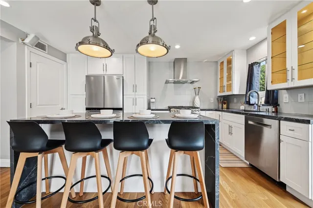 a kitchen with stainless steel appliances granite countertop a stove and a sink