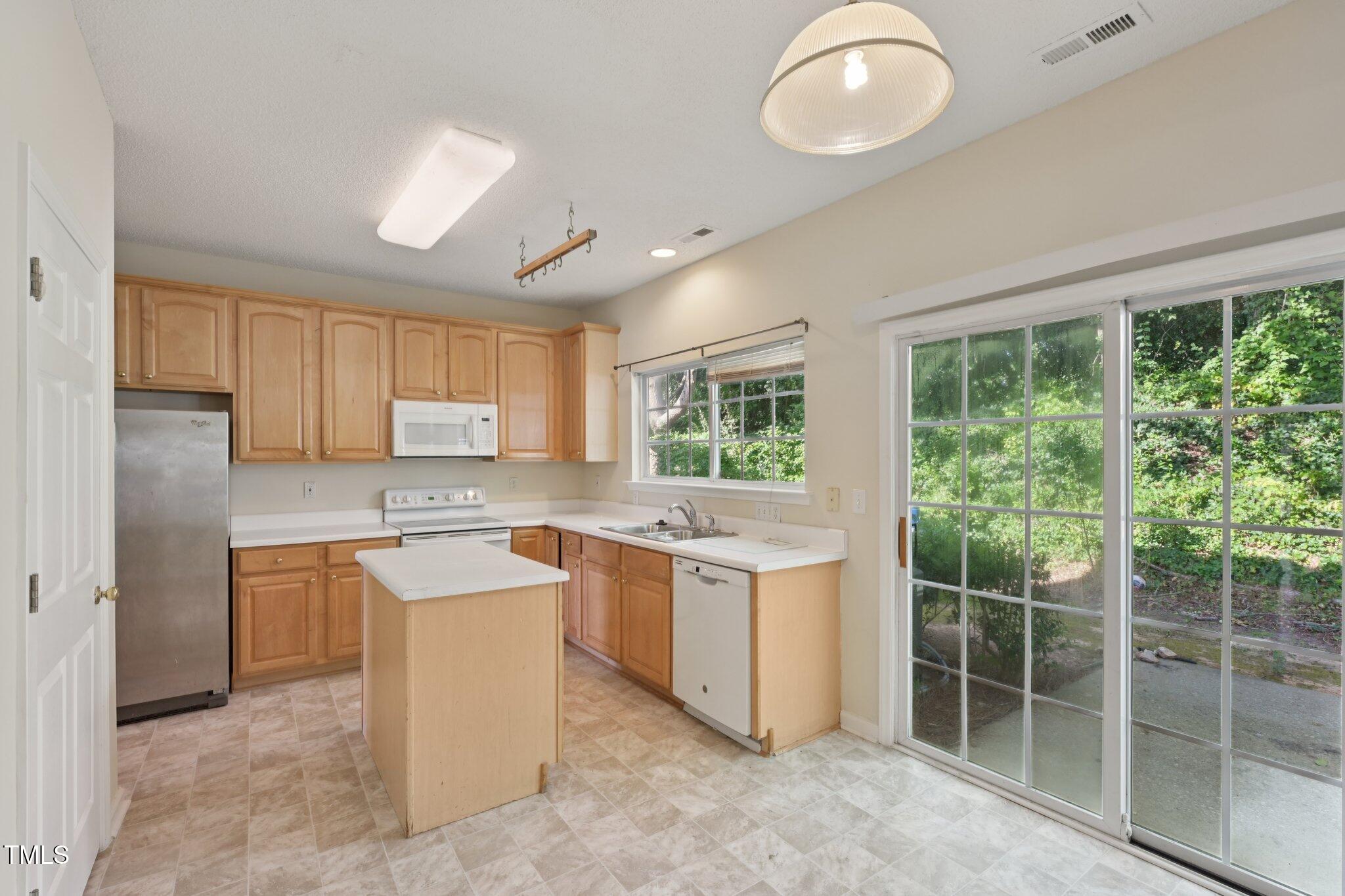 1031 Lake Moraine Place Raleigh, NC 27607 - Photo 13 of 33 a kitchen with a sink stove and cabinets