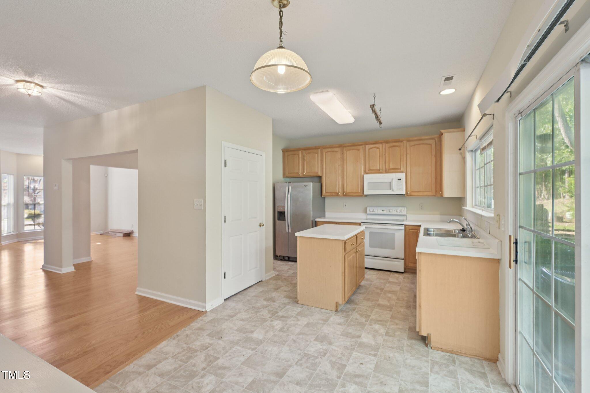 1031 Lake Moraine Place Raleigh, NC 27607 - Photo 14 of 33 a view of kitchen with stainless steel appliances granite countertop a sink and a refrigerator