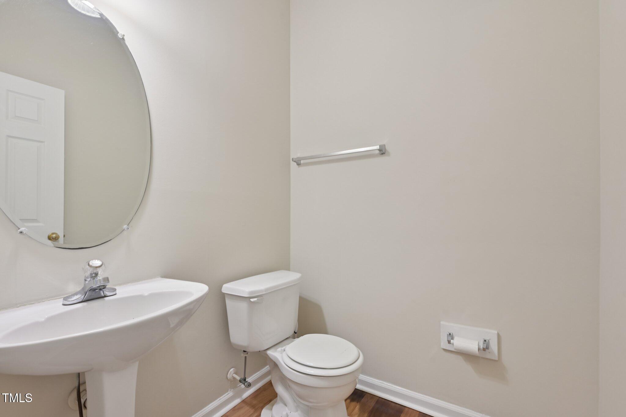 1031 Lake Moraine Place Raleigh, NC 27607 - Photo 17 of 33 a bathroom with a sink a toilet and a mirror