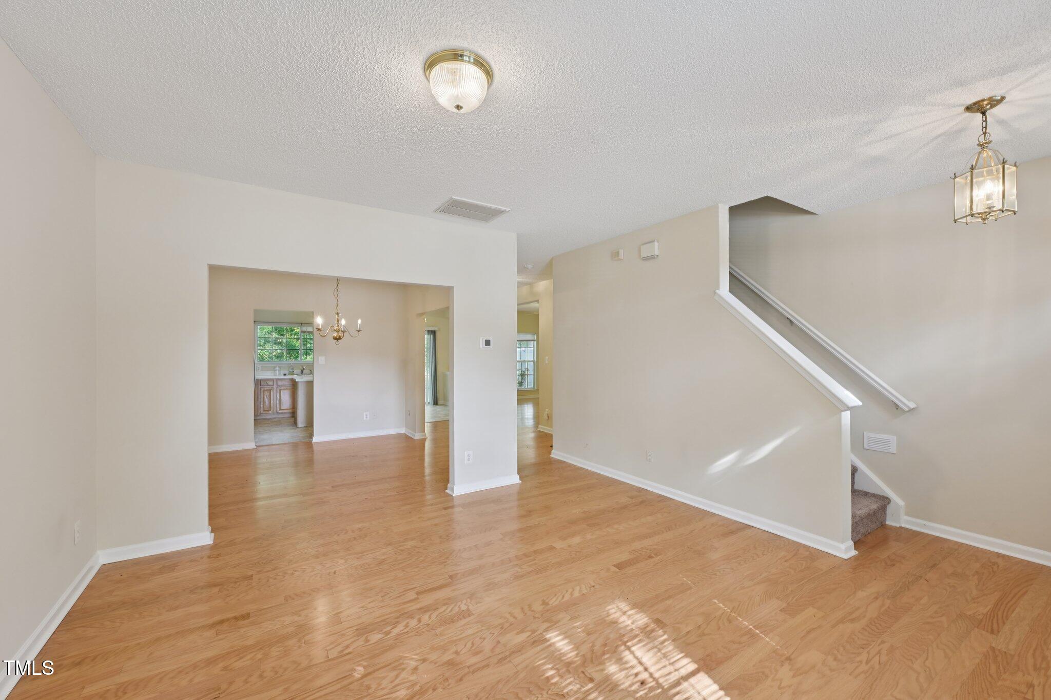 1031 Lake Moraine Place Raleigh, NC 27607 - Photo 4 of 33 a view of an empty room with wooden floor and a window