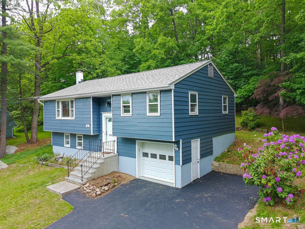 17 Rhoda Lane Bristol, CT 06010 - Photo 1 of 22 a front view of a house with garden