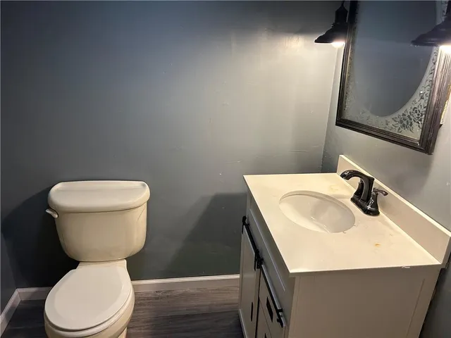 a bathroom with a sink a toilet and a mirror