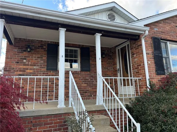 a view of a brick house with large windows