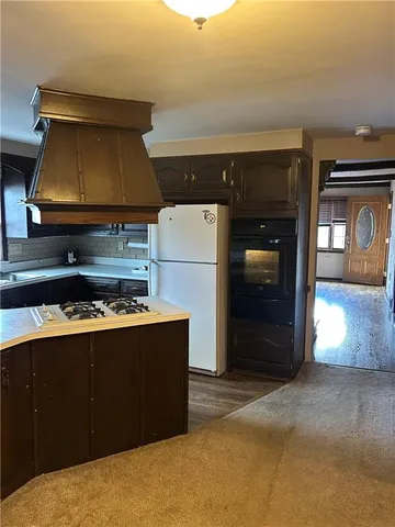 a kitchen with a stove and a refrigerator