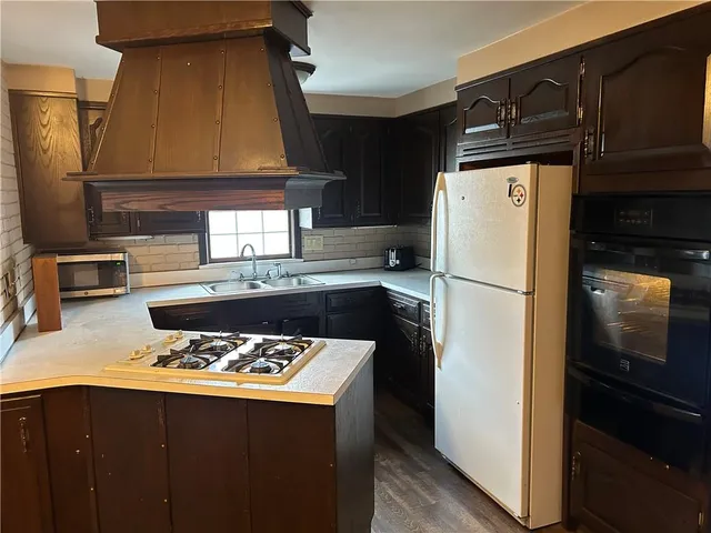 a kitchen with a refrigerator and a sink