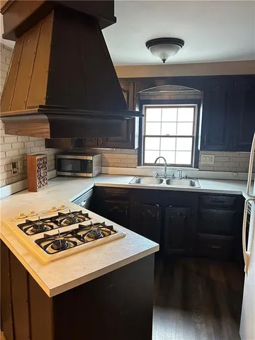 a kitchen with a stove and a sink