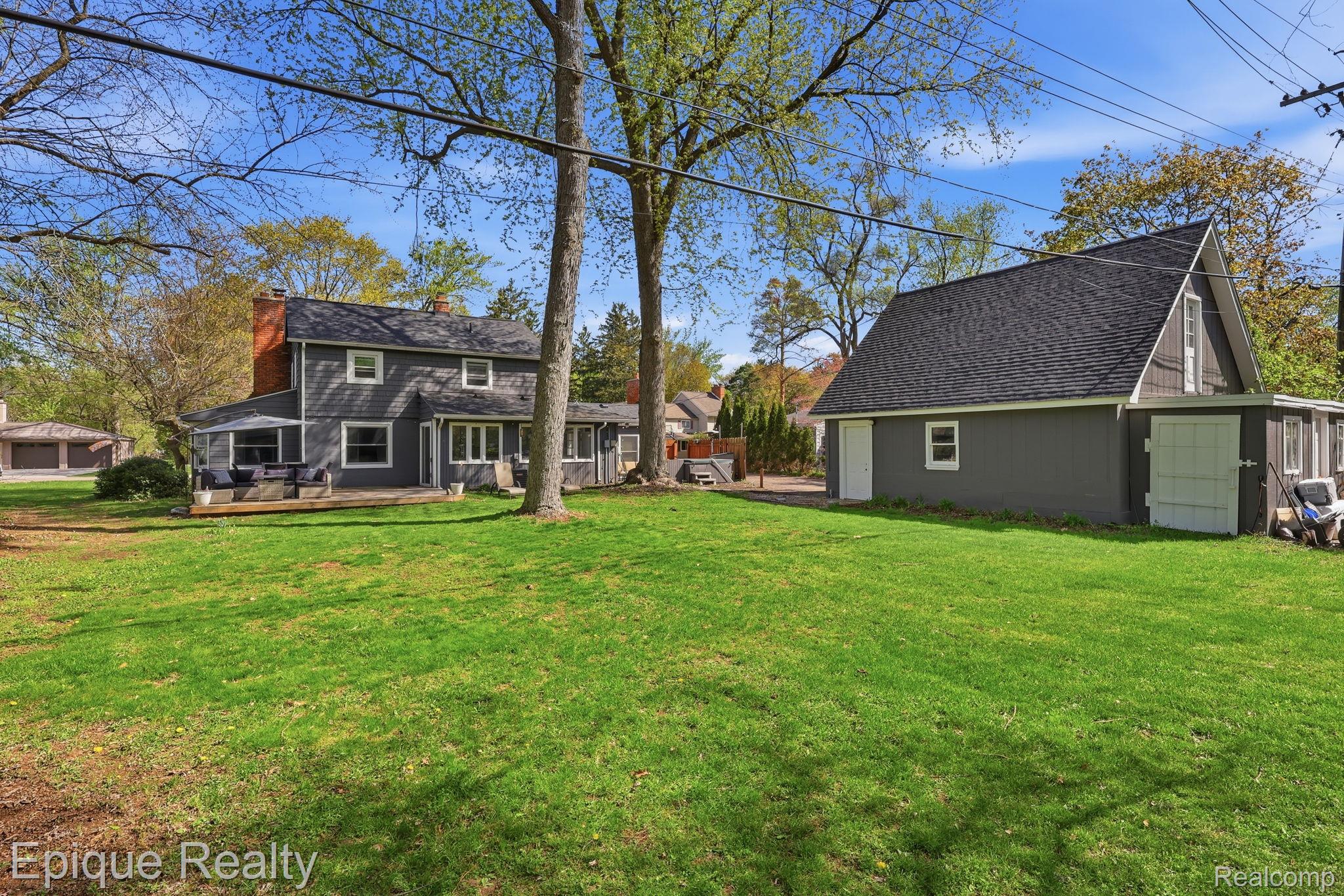 7441 Honeysuckle Road West Bloomfield, MI 48324 - Photo 28 of 35 View of grassy yard with an outdoor structure and a wooden deck