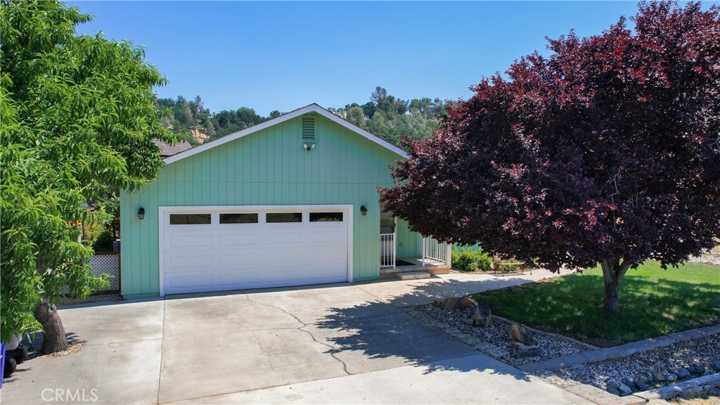 19942 Mountain Meadow South Hidden Valley Lake, CA 95467 - Photo 1 of 40 a front view of a house with garden