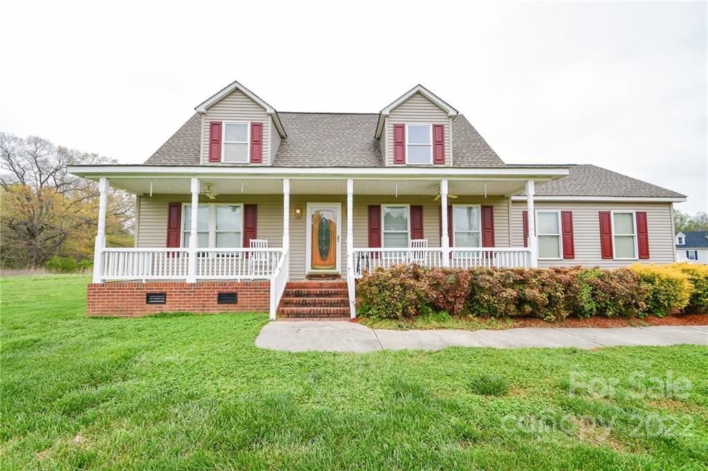 3916 Old Camden Road Monroe, NC 28110 - Photo 1 of 18 a front view of a house with a yard