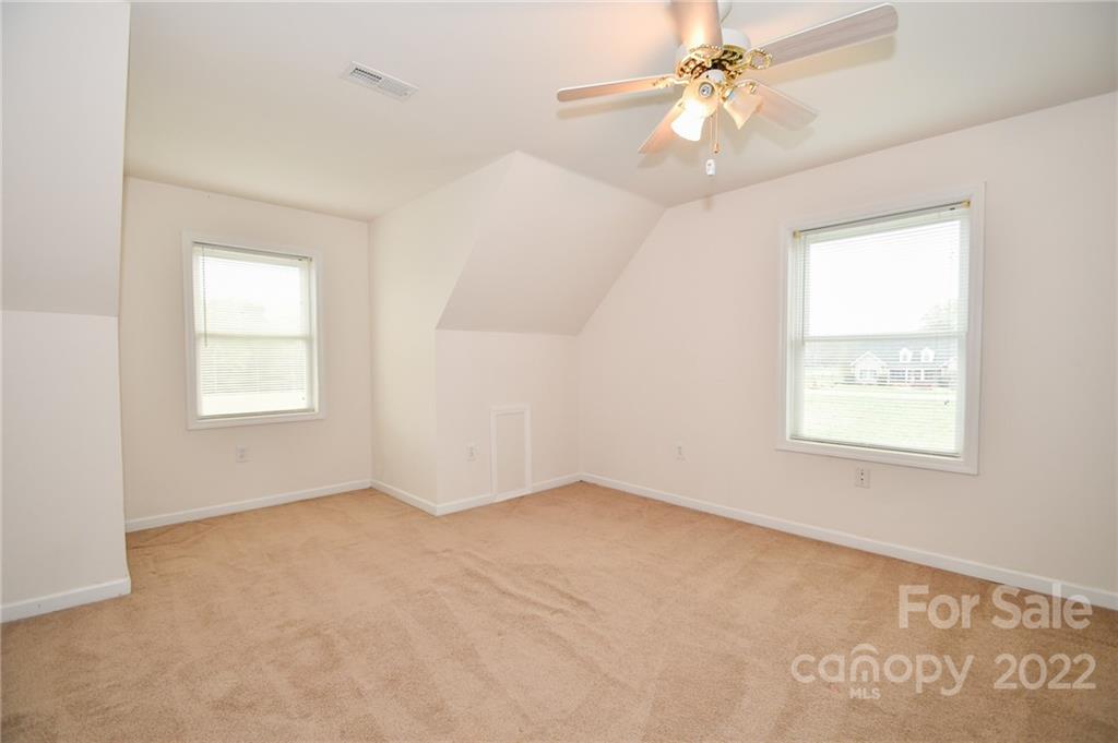 3916 Old Camden Road Monroe, NC 28110 - Photo 16 of 18 an empty room with windows and fan