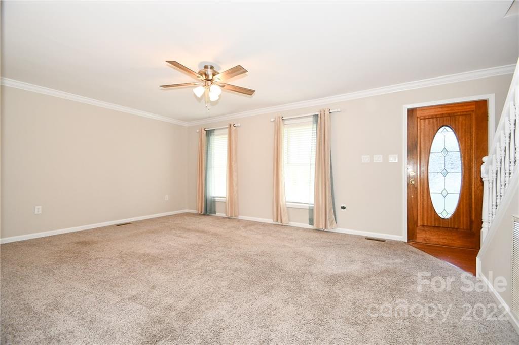 3916 Old Camden Road Monroe, NC 28110 - Photo 8 of 18 an empty room with a window and a ceiling fan
