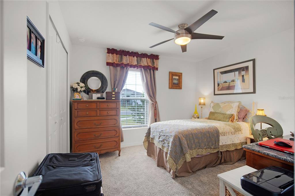 287 Inman Boulevard Winter Haven, FL 33881 - Photo 15 of 19 a bedroom with a bed and a chandelier