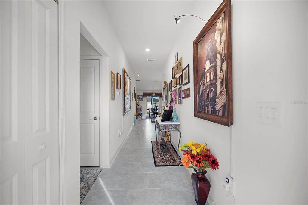 287 Inman Boulevard Winter Haven, FL 33881 - Photo 5 of 19 a hallway with painting on the wall and a potted plant