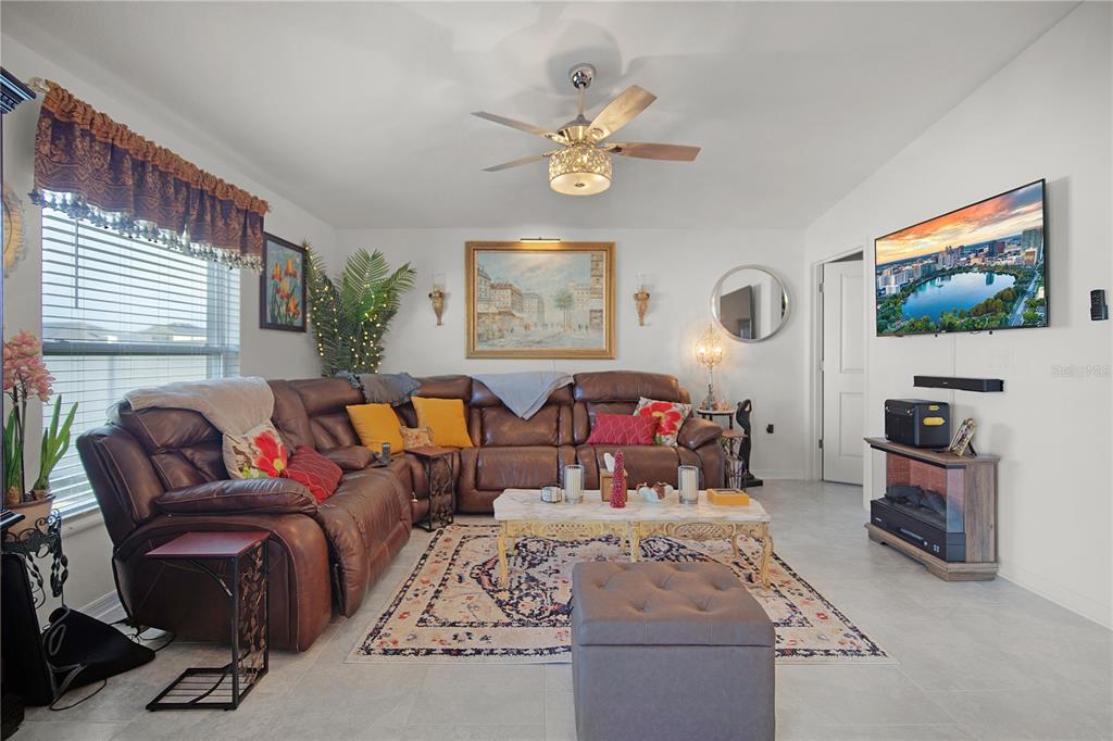 287 Inman Boulevard Winter Haven, FL 33881 - Photo 8 of 19 a bed room with furniture and a flat screen tv